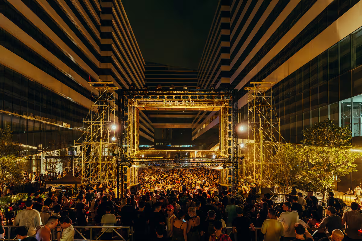 The park stage lit between the Cloud 11 towers