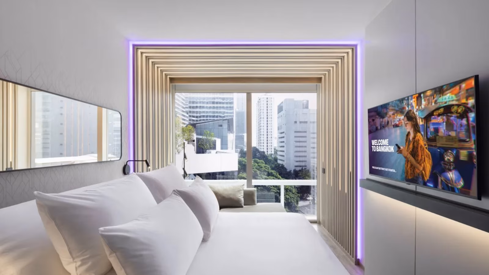 YOTEL Cloud 11 bed looking out over the park and Bangkok skyline